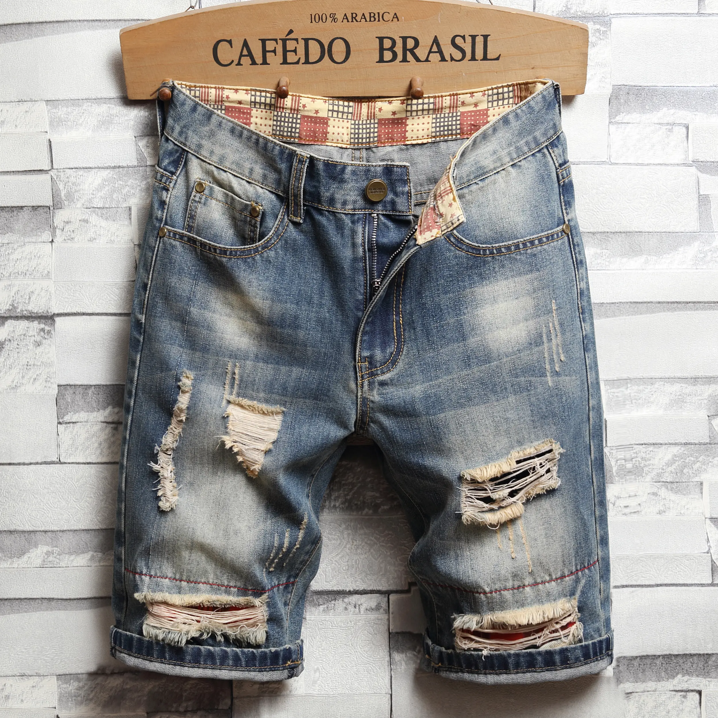 Grunge vintage distressed denim shorts with frayed details and rolled cuffs