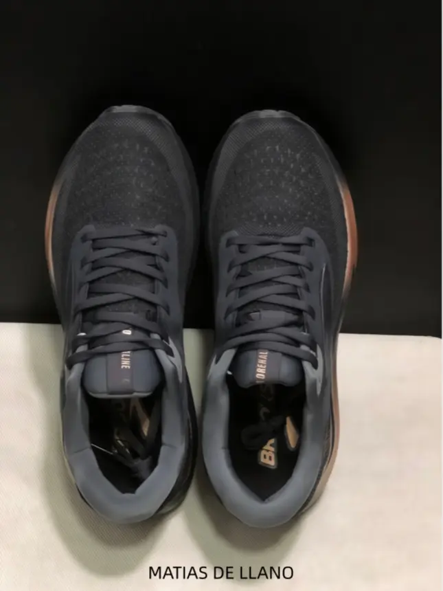 These sleek black running shoes with rose gold midsole accents deliver a modern, performance-driven look that pairs effortlessly with casual shorts for gym sessions, weekend walks, or urban commutes without sacrificing cushioning or stability.