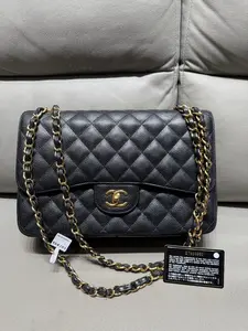 Pre-owned CHANEL jumbo black caviar gold hardware
