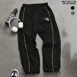 Men’s casual pants with side stripes, featuring trendy Y2K street style that’s versatile; elastic waistband with drawstring design; American retro cross pattern print; lightweight, breathable, and comfortable—ideal for everyday wear and easy styling.