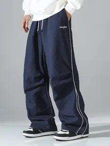 Summer loose men’s athletic pants, Bubble check fabric for pants lightweight soft fabric, oversized fit, gray side stripe with gold decorative stripe, comfortable design, casual sports bottoms for fitness wear, 100% polyester fiber