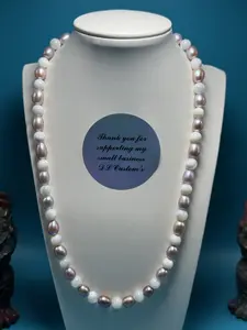 Radiant cultured freshwater pearl and trochid shell bead necklace.