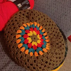 Crochet Bonnet with Colorful Central Design and Red Surrounding Element