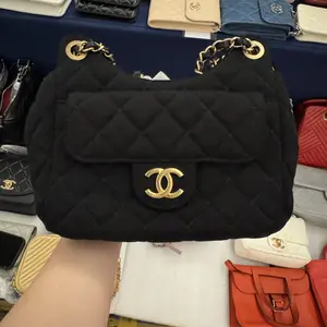 Pre-owned CHANEL H5 black denim bag with gold hardware and a CF flap closure, model BZ0603005