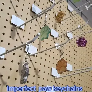 Imperfect Paw Keychains - Unique Design Keychains Displayed on Pegboard