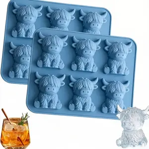 2 pc of a Light Blue Silicone Mold Featuring Six Cavities Shaped Like 3D Highland Cows, Perfect for Creating Cute Ice Cubes for Whiskey Cocktails. This Reusable Tray Can Also Be Used for Making Chocolate, Candy, Or Soap