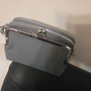 Elegant Gray Leather Crossbody Bag with Silver Hardware and Dual Zipper Closure for Everyday Use