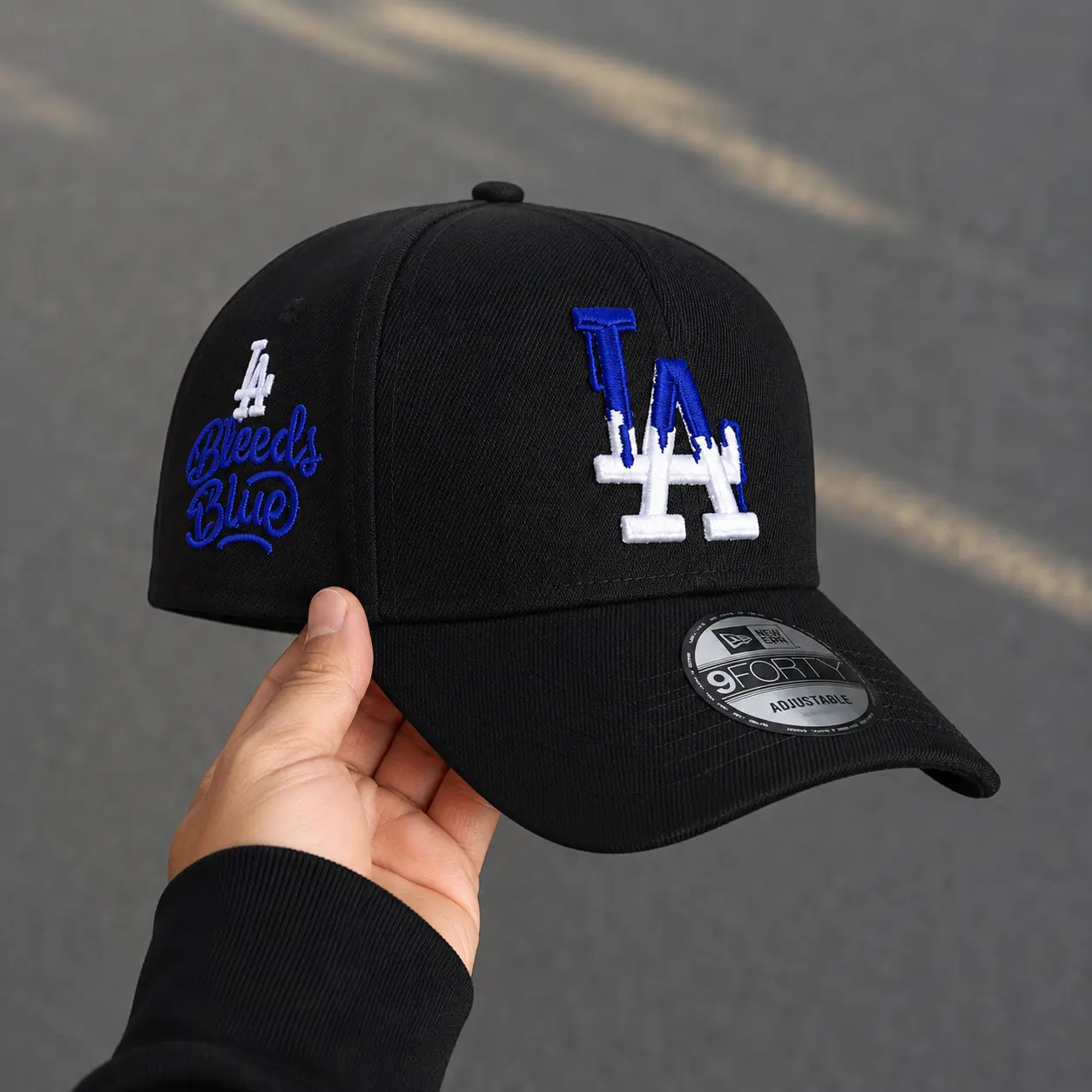 New Era Los Angeles Dodgers LA MLB 9FORTY Adjustable Baseball Cap Black Curved Brim Blue White Embroidered LA Logo Bleeds Blue Side Embroidery Streetwear Urban Fashion Unisex Casual Baseball Hat Limited Edition Collectible Fan Cap