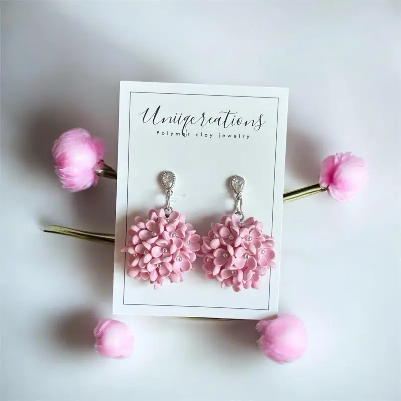 Pink bouquet flower dangles on a diamond stud.