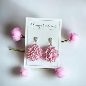 Pink bouquet flower dangles on a diamond stud.