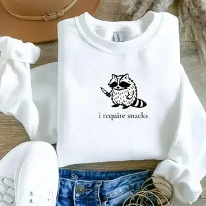 I Require Snacks raccoon sweatshirt with a sarcastic, funny design, cozy crewneck perfect for snack lovers who enjoy humor and cute animal vibes.