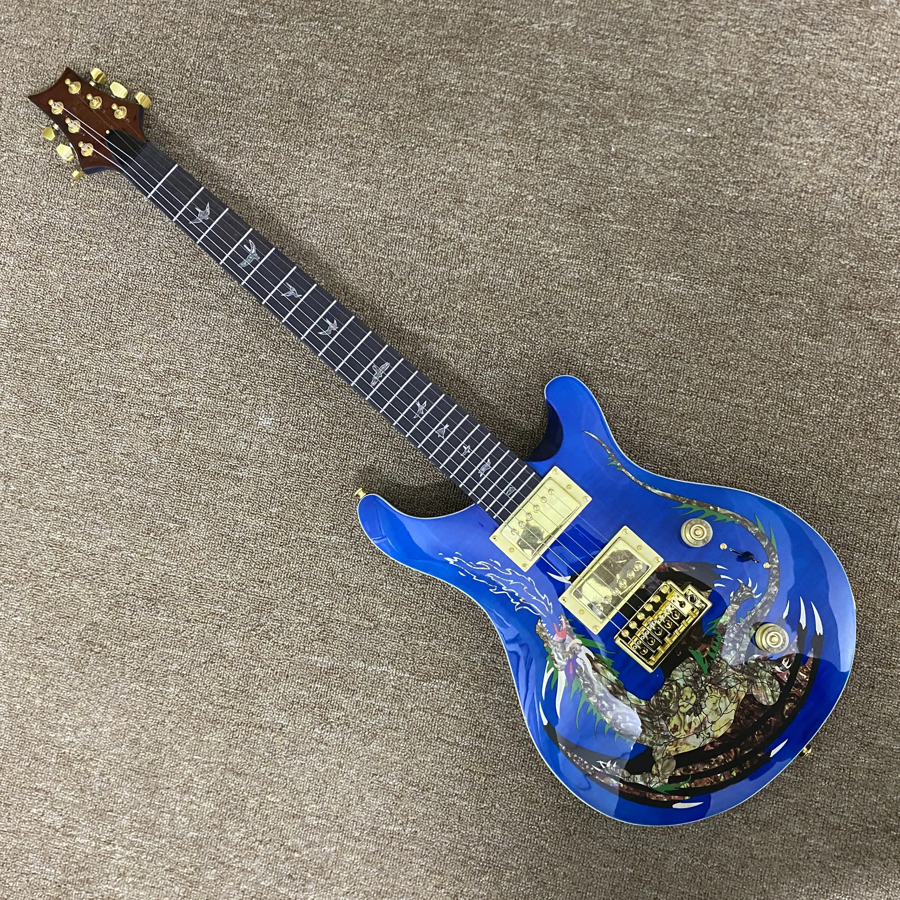Blue 6-string PRS electric guitar with gold hardware, rosewood fretboard and mahogany body, 24 frets.