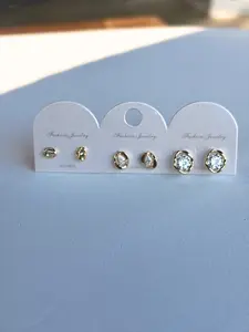 Molten Glow Stud Set — 14K Gold Plated A trio of sculptural gold-plated studs with a smooth organic mini stud, an oval liquid bezel with a sparkling CZ, and a bold wavy-set crystal. Perfect for stacking, mixing, and everyday minimal wear.
