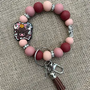 Silicone & rhinestone wristlet keychain. #highland cow#cross