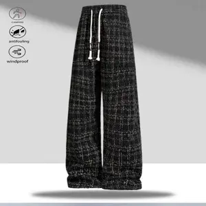 A pair of plaid wide leg casual pants, featuring a casual trendy style with an adjustable drawstring waistband following current trends, stylish plaid pattern design, and fashionable ankle drawstrings with trendy elements. The overall shape meets today's
