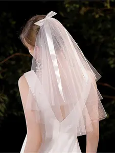 A romantic bridal veil with pearl embellishments - elegant tulle veil with comb - bow ribbon, forest-inspired vintage fairy elegance - suitable for dream weddings, proposals, and ideal photography props, registry, wedding parties, formal ceremony accessor