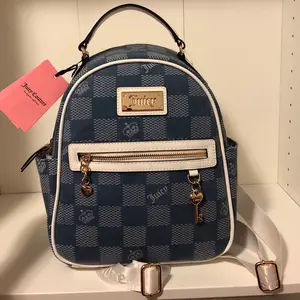 Juicy Couture - Miss independent medium wash denim backpack.