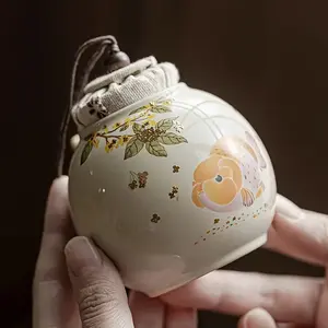 Ceramic Tea Canister with Handle - Floral & Fish Design, Airtight Food-Safe Storage Jar for Loose Leaf Tea, Kitchen Countertop Organizer, Decorative Ceramic Container, Rustic Aesthetic, Natural Elements Decor