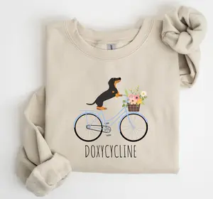 Doxycycline Pun Sweatshirt – Dachshund on Bicycle, Funny Pharmacy or Vet Gift