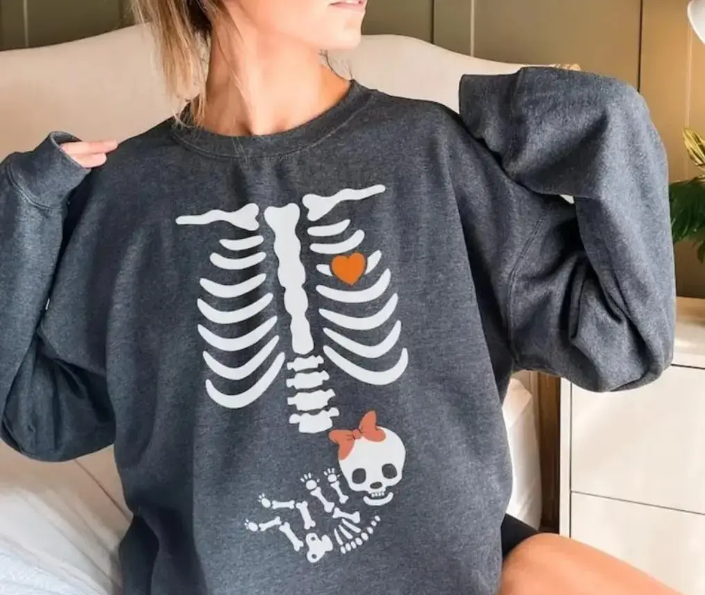 Cute Skeleton Baby Girl Pregnancy T-Shirt, Sweatshirt, Hoodie – Funny Halloween Maternity Shirt With Ribs, Heart, And Fetal Skeleton Design For Expecting Moms