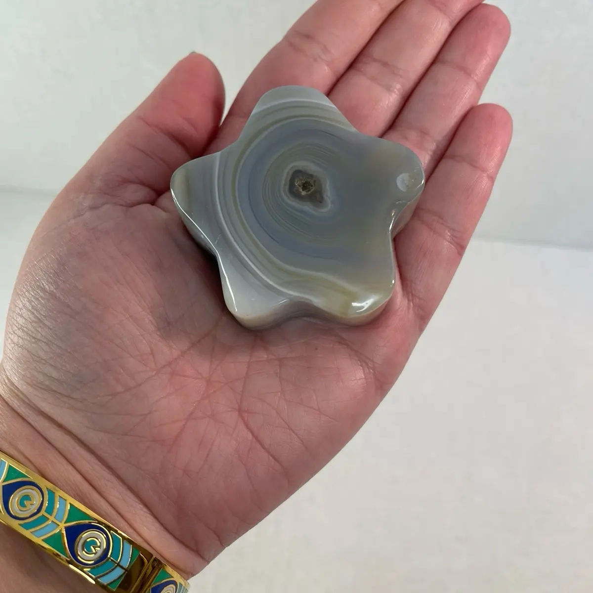 Small polished gray banded agate crystal star carving