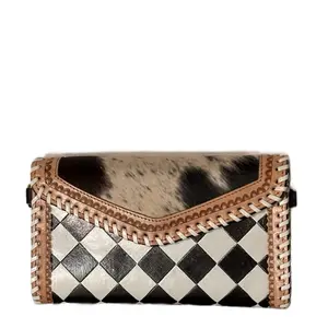 Hand painted leather clutch featuring real hair on hide front-comes with adjustable strap