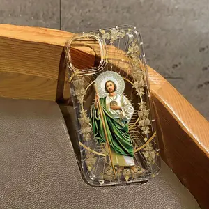 This transparent TPU phone case features a gold leaf pattern of Jesus and is designed for shock and slip resistance. It has a large aperture lens and is compatible with iPhone 17, 16, 15, 14, 13, 12, 11, XS, X series, and makes a great gift for friends