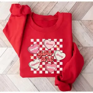 Conversation Hearts sweatshirt, a cute Valentine’s Day sweater featuring heart-candy designs like “I Love You” and “Be Mine,” perfect for couples or festive outfits.