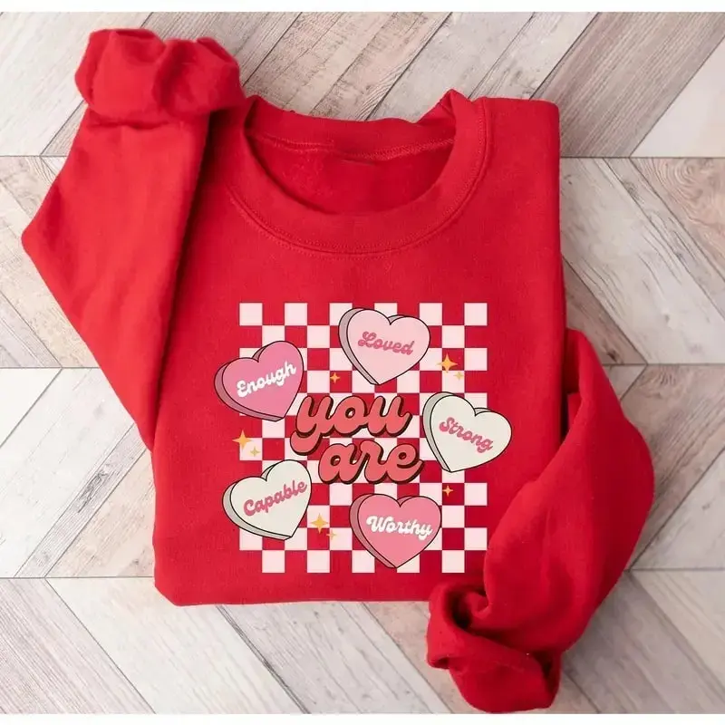 Conversation Hearts sweatshirt, a cute Valentine’s Day sweater featuring heart-candy designs like “I Love You” and “Be Mine,” perfect for couples or festive outfits.
