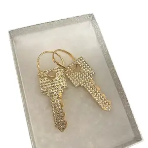 Gold Key Earrings with Decorative Design, Secure Clasp, and Decorative Elements