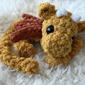 Handmade Crochet Dragon Plushie Gold Color Soft Plush Material Cute Design Approximately 8 Inches in Body Length & 12 Inches with Tail Perfect for Cuddling and Gifting