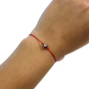 Adjustable red cord with evil eye. Protection