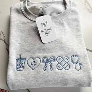 [MADE IN US] Coquette Nurse Embroidered Sweatshirt, Cute Cotton Crewneck, Cozy Womenswear Gift for CNA or Nursing Student, Soft Aesthetic Everyday Outfit