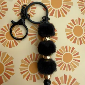 Black Keychain with Faux Fur Pom Poms and Gold Accents