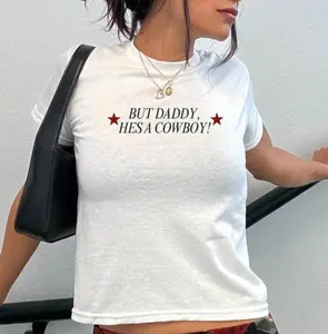 But Daddy he's a Cowboy Baby Tee G5000B+Crop Top Rodeo Country Western American Country Phrase 90s style Baby Tee