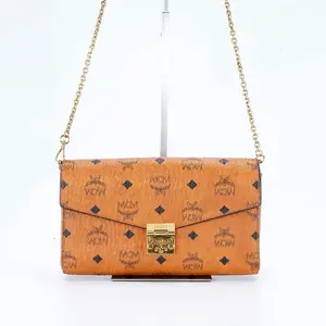 Pre-owned MCM medium envelope bag with chain strap, brandy color