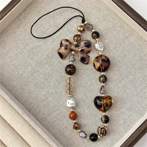 1pc Stylish Mobile Phone Chain Featuring A Leopard Print Bow And Beads, Designed As A Short Wrist Accessory. This Multifunctional Retro Pendant Is Perfect For Women, Serving As An Anti-Lost Hanging Chain For Phone Cases