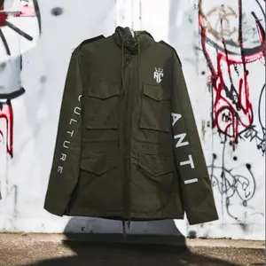 ANTI CULTURE Olive Revolution Jacket - Durable Olive Green Shell with Utility Pockets & Graffiti-Style Sleeve Prints - Relaxed Fit for Urban Layering