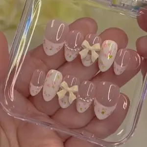 Romantic pastel floral press on nails with soft pink blossom tips, 3D cream bows and pearl accents, elegant spring garden princess aesthetic nail set
