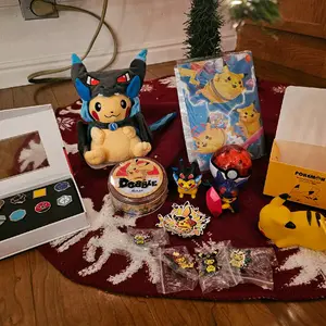 Pokemon Holiday Gift Box with Stuffed Animal, Gym Badge Set, Binder, and More