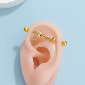 Trendy and fashionable ear studs featuring unique python-shaped industrial barbell crossbars for piercing.