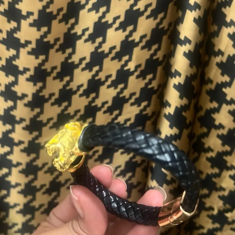 Men’s Black Braided Leather Bracelet with Gold Lion Head  Elevate your style with this bold and powerful black braided leather bracelet, featuring a striking gold lion head centerpiece — a timeless symbol of strength, courage, and leadership.  Made from d