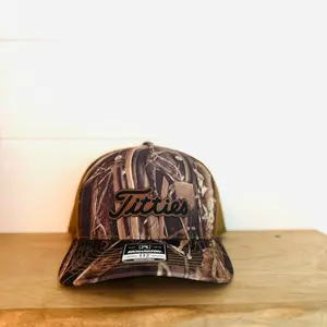 Titties Leather Patch Hat with Camouflage Design and "Titties" Text on Front