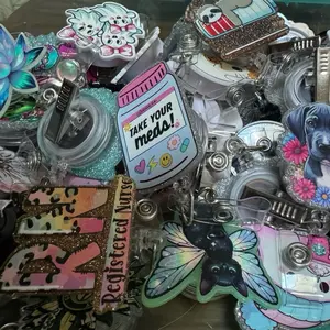 Live Claim Badge Reels and Pens - Assorted Designs Featuring Unique Characters and Themes creative id