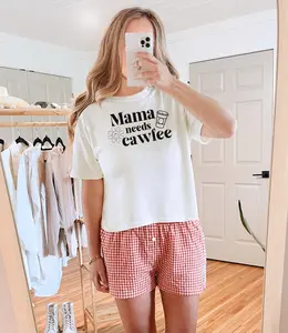 Fun and casual 'Mama Needs Cawfee' boxy tee. A must-have for coffee-loving moms, featuring a playful design and comfy cotton fabric. Perfect for casual days and a great Mother's Day gift