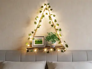 Set of 2 boho-style wall floating shelves, designed with macrame hanging details, artificial ivy and LED lights. Stylish decorative storage for bedroom and living room.