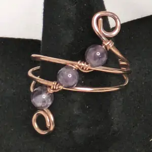 Shenegar Designs copper wire wrapped ring with three woven genuine amethyst stones. Handmade jewelry.