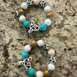 Teal and gold cow wristlet