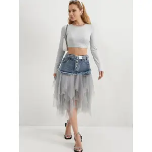 Women’s denim patchwork mesh skirt with a personalized fringed hem—a fashionable, multifunctional piece suitable for all seasons, including spring, summer, autumn, and winter. GARMENTARY