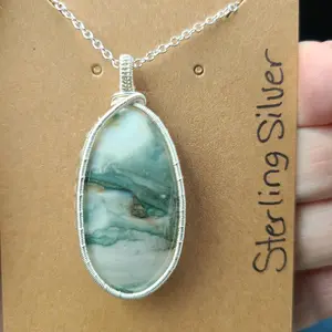 Saturn Chalcedony wire wrapped pendant with silver chain.